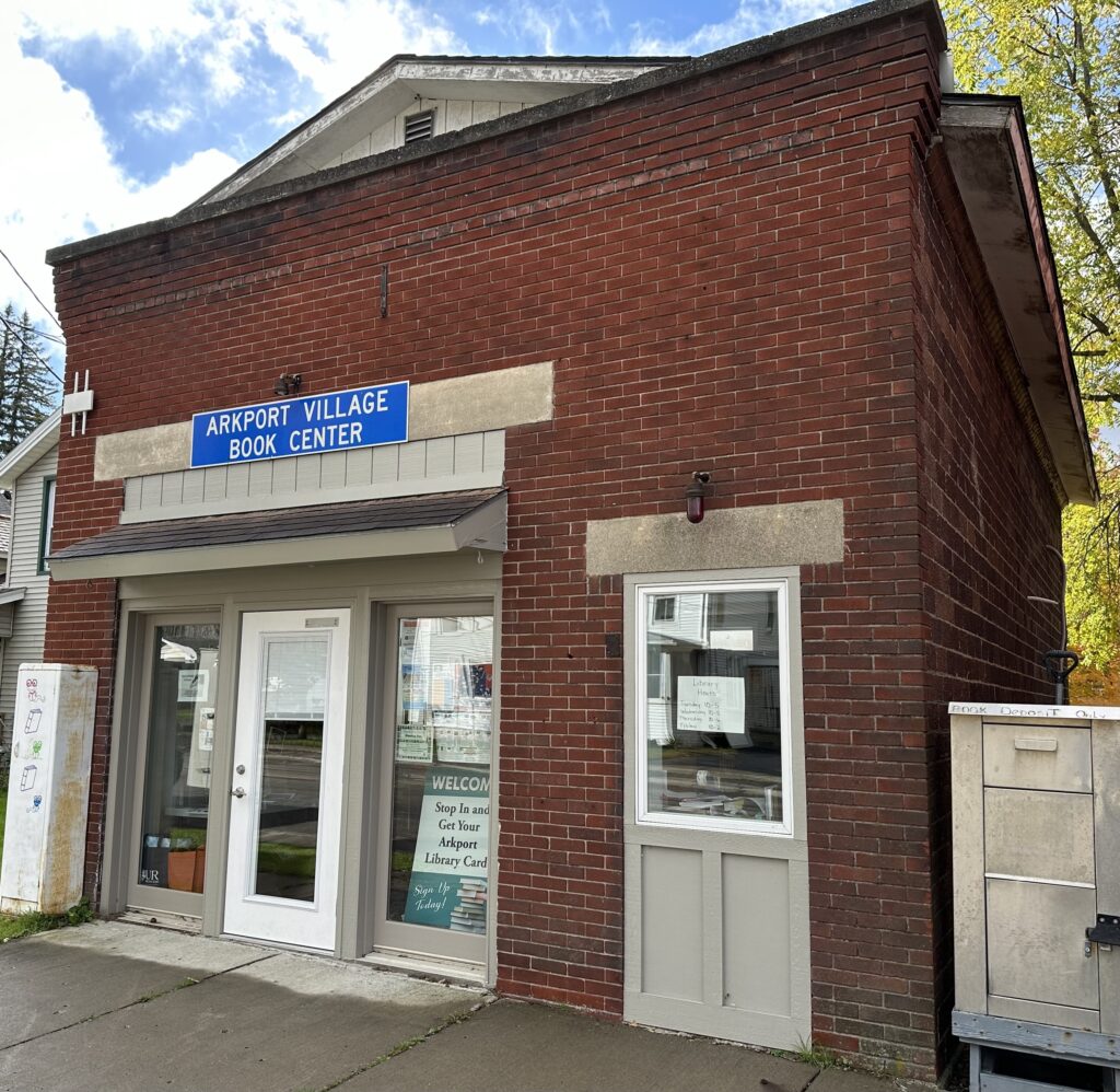 Front of Arkport Public Library Building with a sunny blue sky.